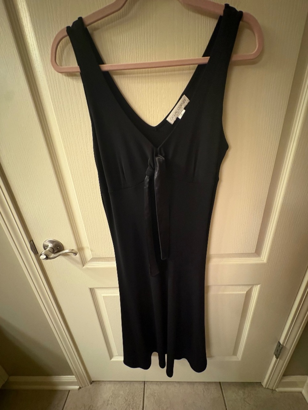 Black dress with silk tie in front.